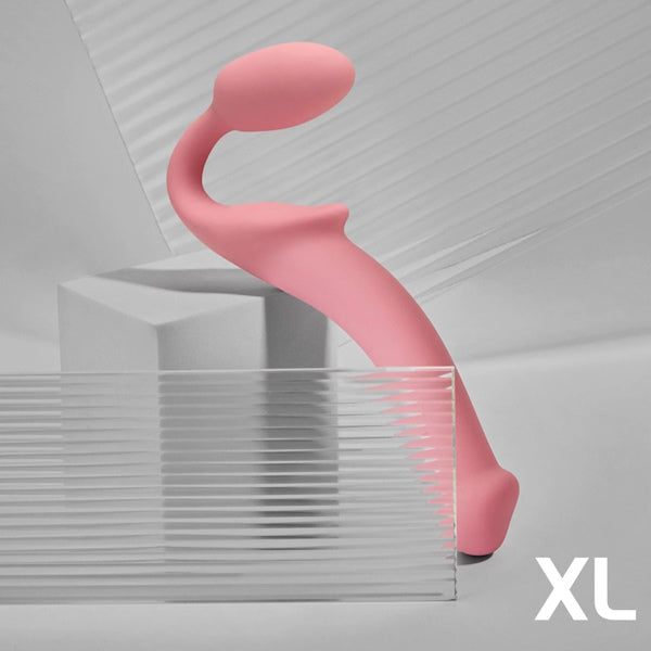 XL pink silicone curved vibrator for adults, modern design, displayed on geometric shapes