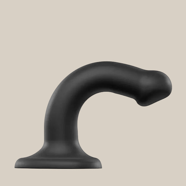 Curved black silicone dildo with a suction base on a neutral background