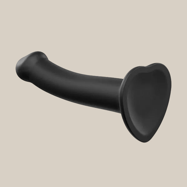 Black silicone heart-base dildo with curved design on a neutral background