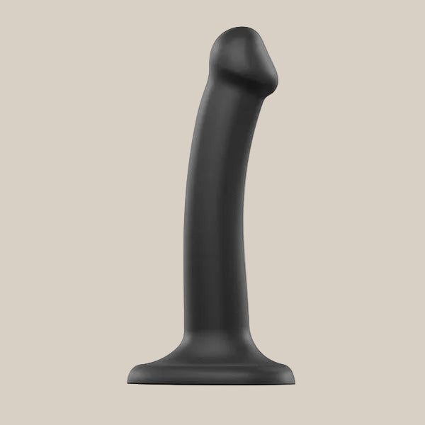 Black silicone dildo with curved shaft and suction cup base on neutral background