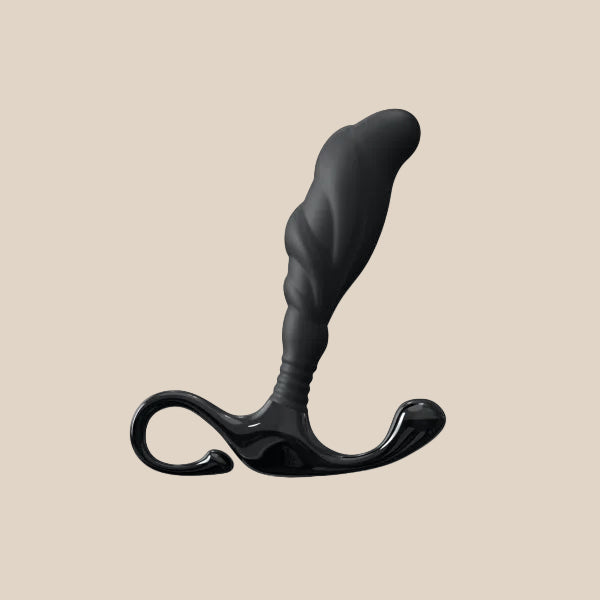 Black silicone prostate massager with textured shaft and ergonomic handle on beige background