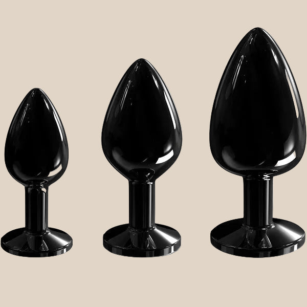 Set of three black silicone tapered plugs in small, medium, and large sizes on white background