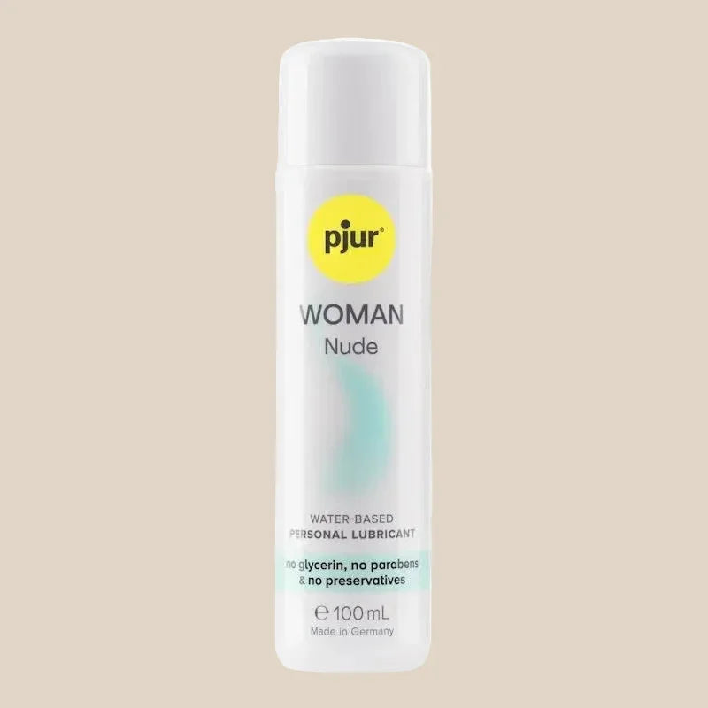 Pjur Woman Nude 100ml water-based personal lubricant bottle on beige background