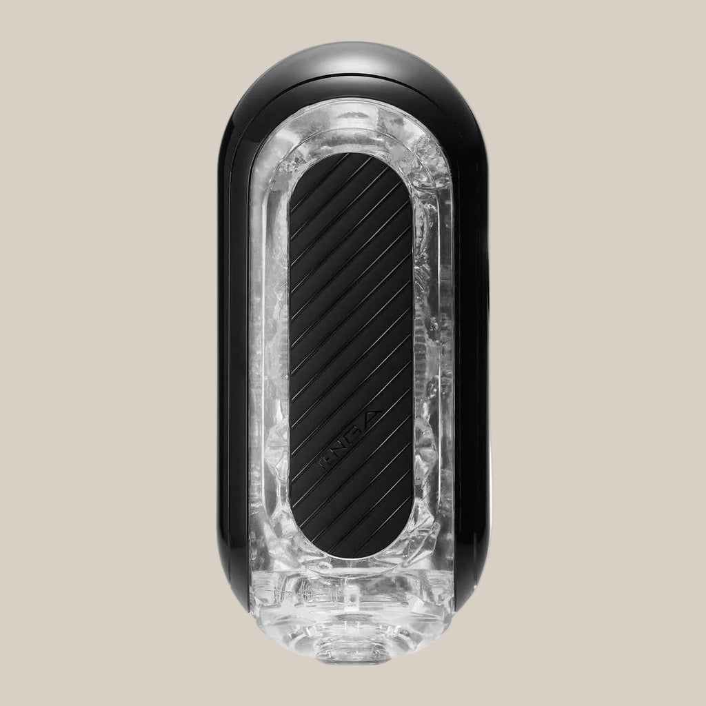Black and clear male pleasure device with textured grip on neutral background
