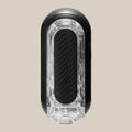 Black and clear male pleasure device with textured grip on neutral background