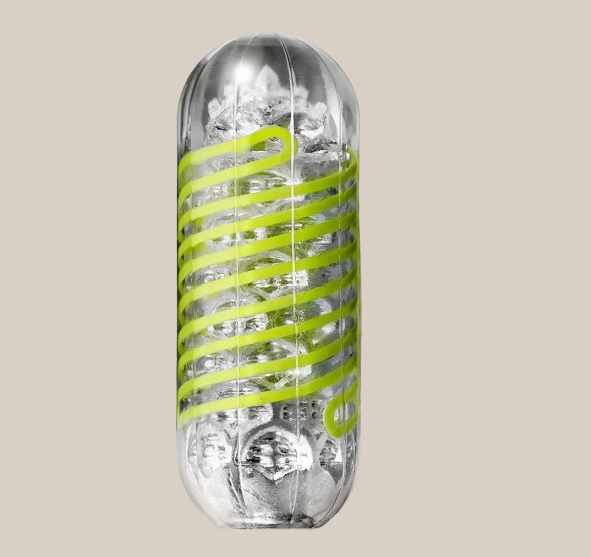 Clear textured adult stroker sleeve with spiral green accent on beige background