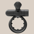 Black silicone vibrating ring with textured inner studs on neutral background