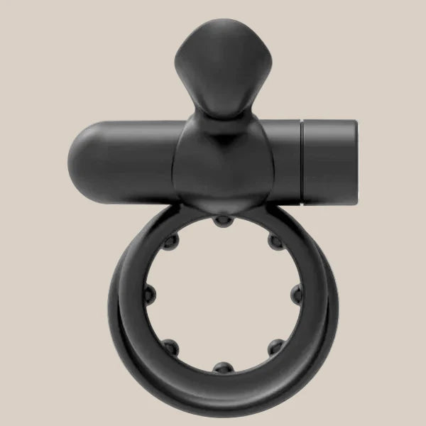 Black silicone vibrating ring with textured inner studs on neutral background
