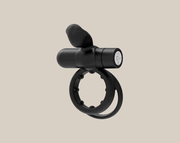 Black silicone vibrating ring for couples on a beige background, body-safe and adjustable.