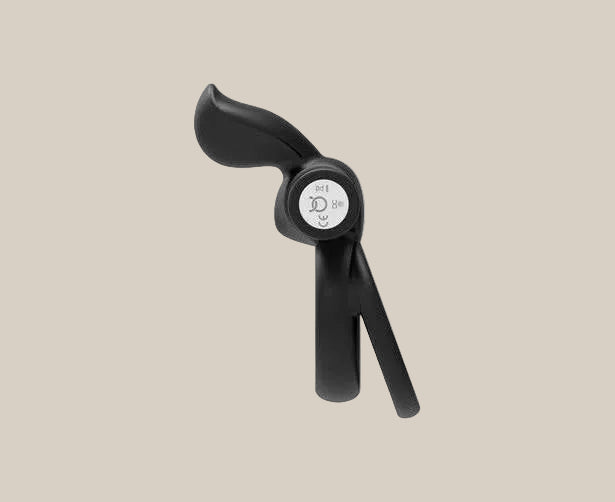 Black silicone adult toy with ergonomic design and silver control buttons on beige background