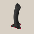 Black silicone curved vibrator with red accents on a neutral background