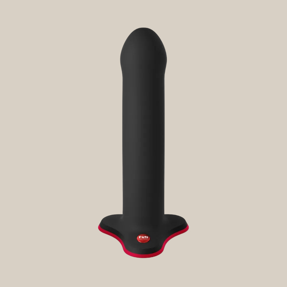 Black silicone adult toy with a flat red-edged base on a neutral background
