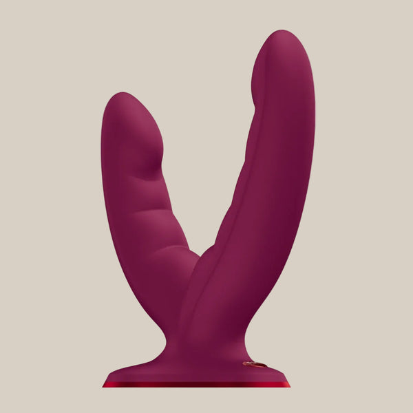 Dual-ended burgundy silicone adult pleasure toy with textured design on neutral background
