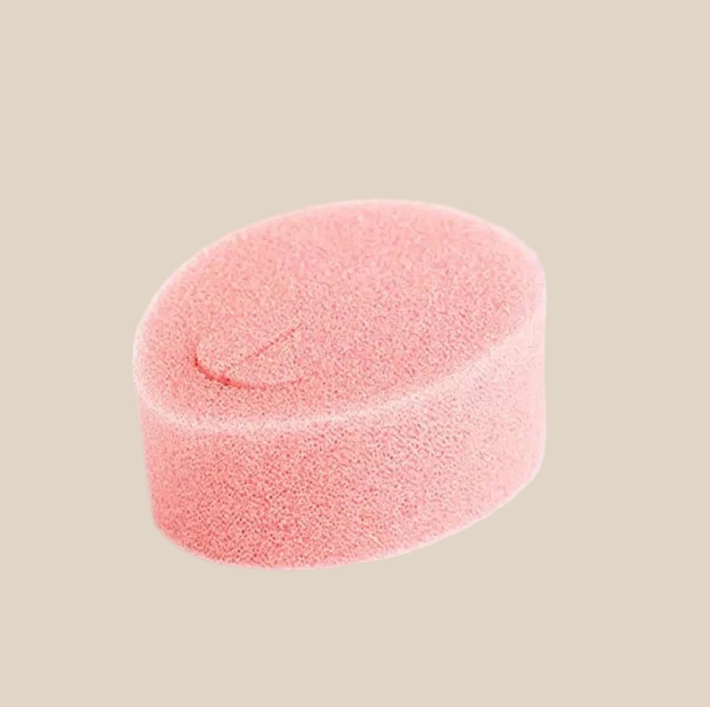 Soft pink oval sponge on white background, intimate hygiene accessory
