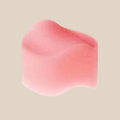 Pink body-safe foam intimacy sponge on white background