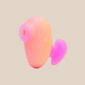 Pink and orange silicone suction stimulator for intimate pleasure, isolated on white background