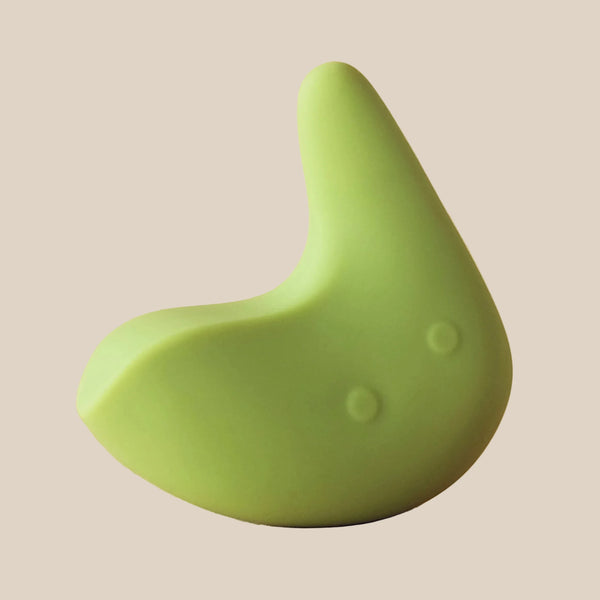 Green silicone intimate massager with ergonomic design on a beige background