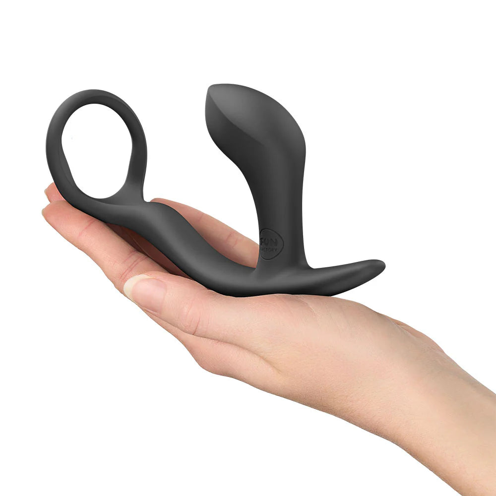 Black silicone prostate massager with ring, held in a hand, body-safe adult toy