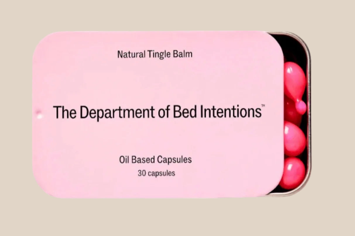 Pink tin labeled Natural Tingle Balm with oil based capsules inside, intimacy essentials