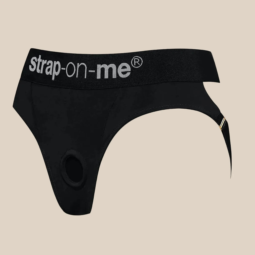 Black strap-on harness with adjustable waistband and logo, designed for adult intimacy.