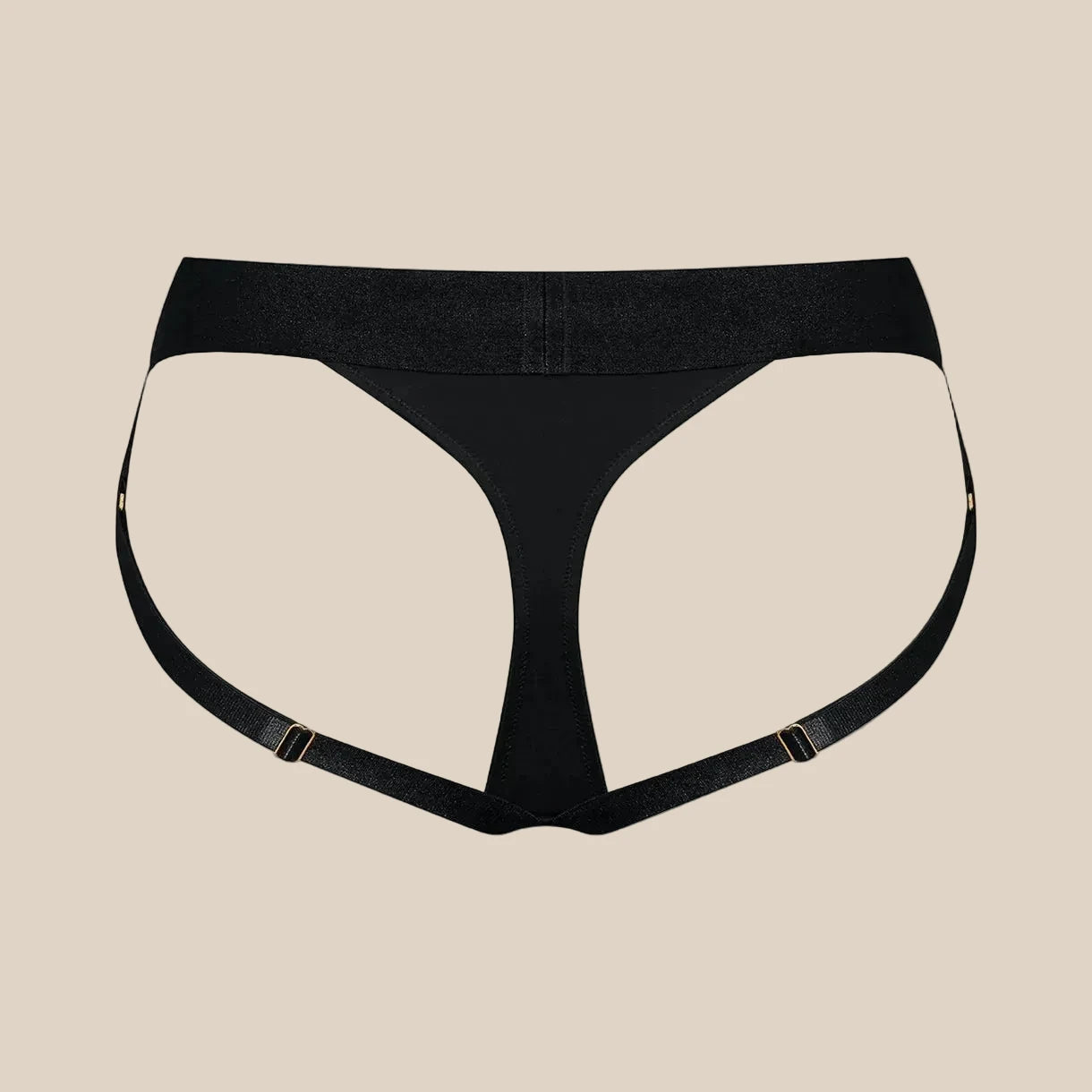 Black strappy thong with adjustable side straps on beige background, modern intimate wear