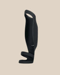 Black silicone vibrating couples toy with ergonomic handle and curved design on beige background.