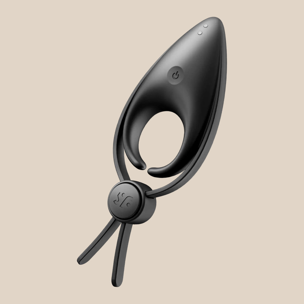 Black silicone rechargeable vibrating couples ring with adjustable strap, isolated on white