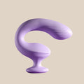 Purple silicone curved vibrator for adult pleasure on neutral background