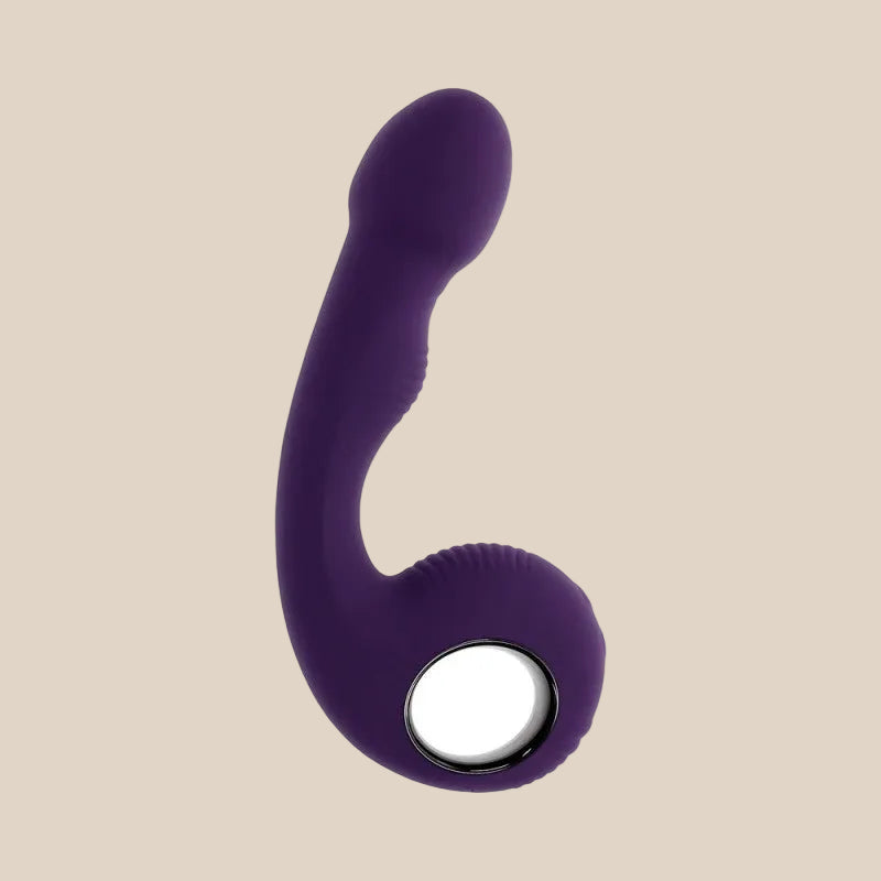 Purple silicone curved adult toy with ergonomic handle on a neutral background.