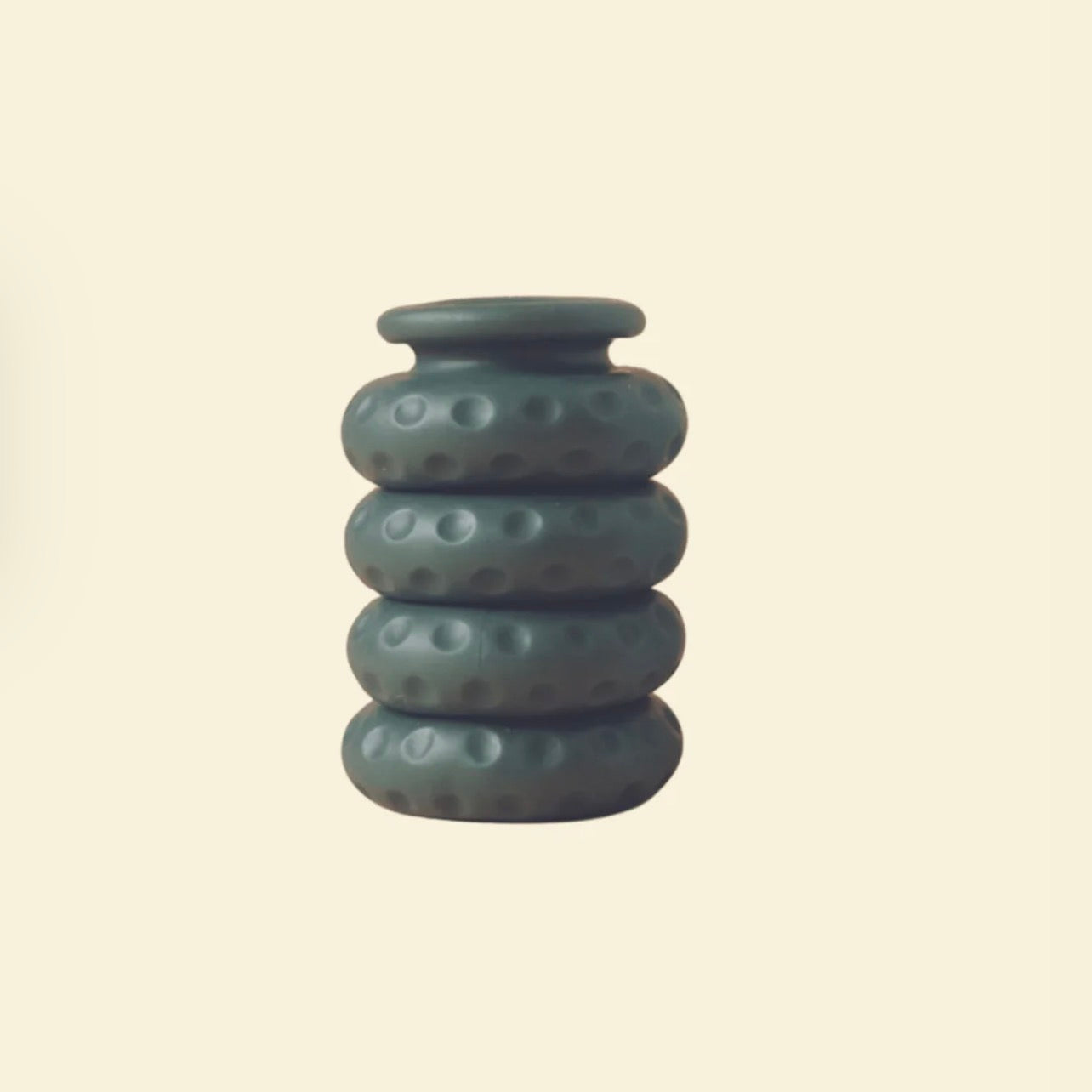 Textured silicone ring stack on neutral background, discreet adult accessory