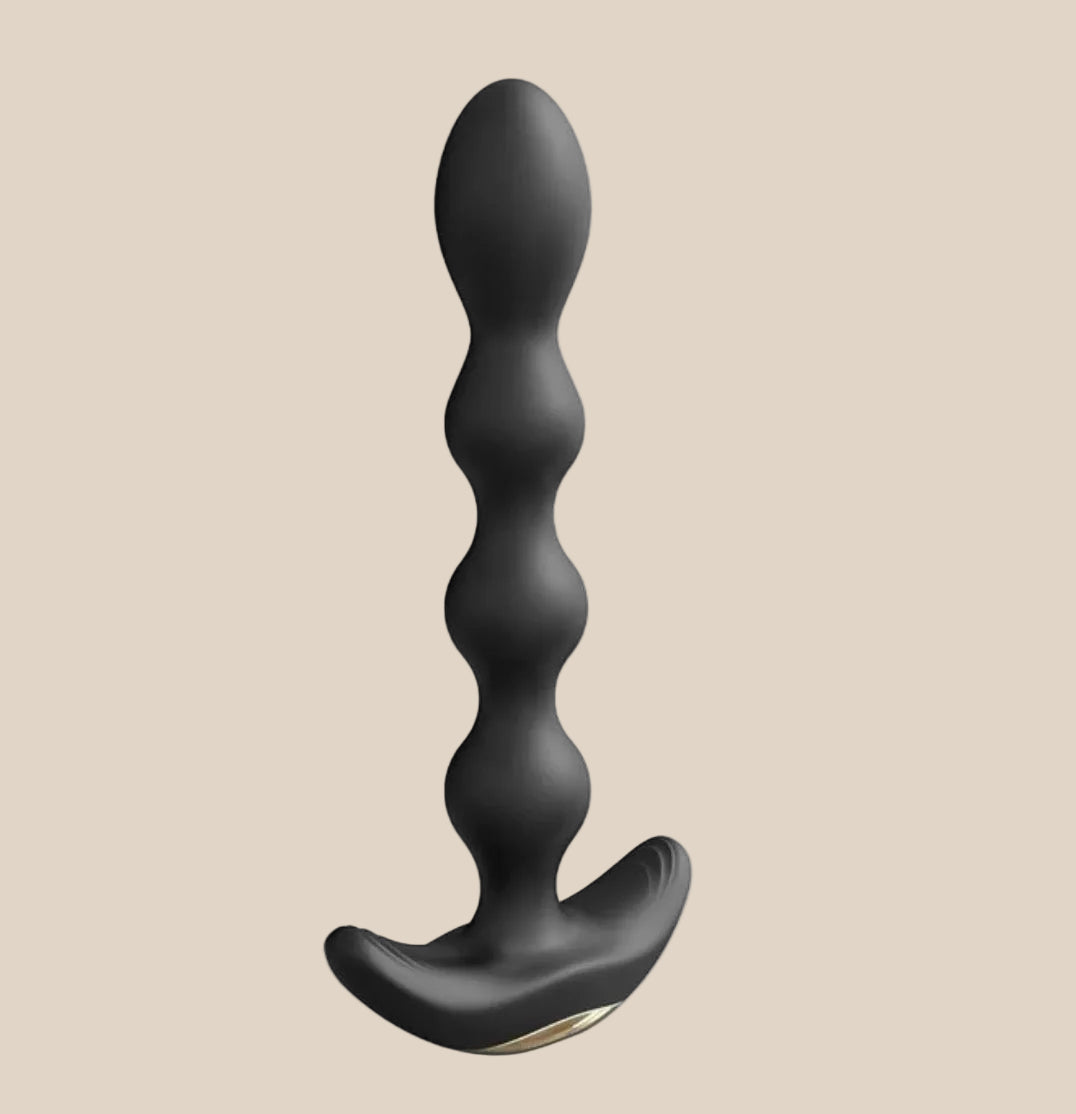 Black silicone beaded anal plug with curved base on neutral background