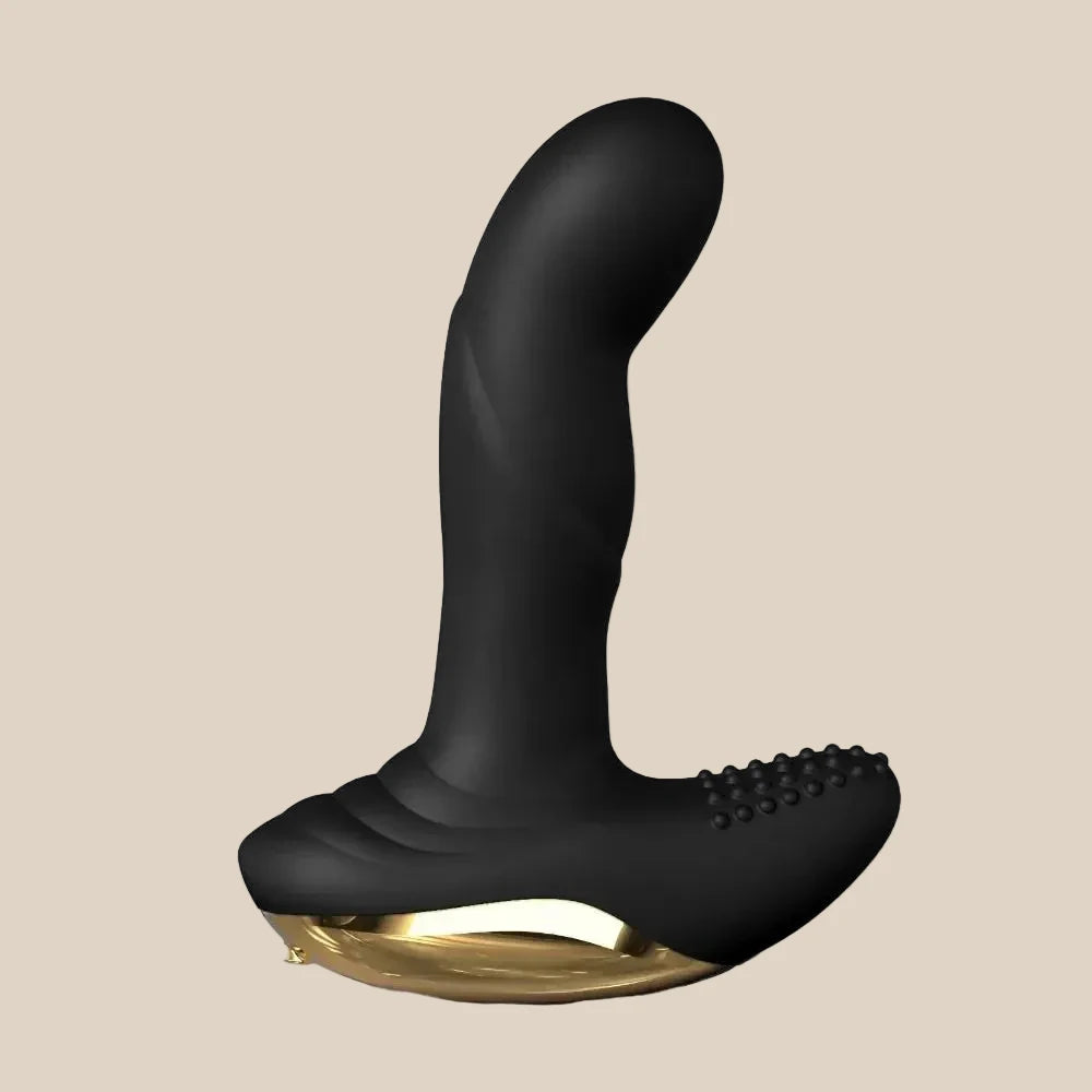 Black silicone prostate massager with gold accent on a neutral background