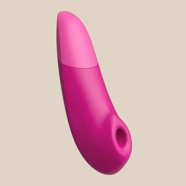 Vibrant Pink Womanizer Enhance 2-in-1 air and vibration toy at Noirette.