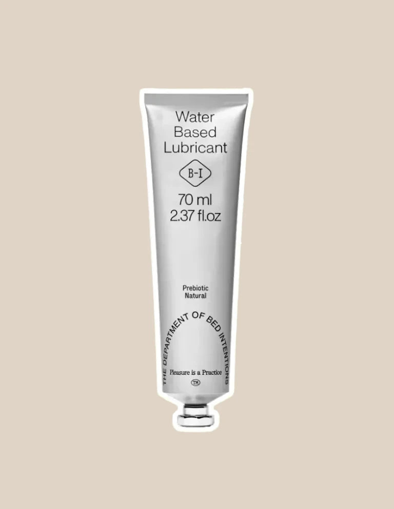 Silver tube of water-based lubricant, 70ml, labeled prebiotic and natural, on beige background
