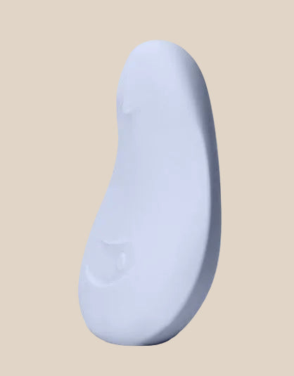 Side view of the Ice Dame Pom showing its ergonomic, palm-fitting shape.