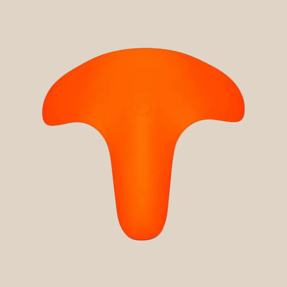 Bright orange flexible medical-grade silicone adult toy with ergonomic shape on beige background.