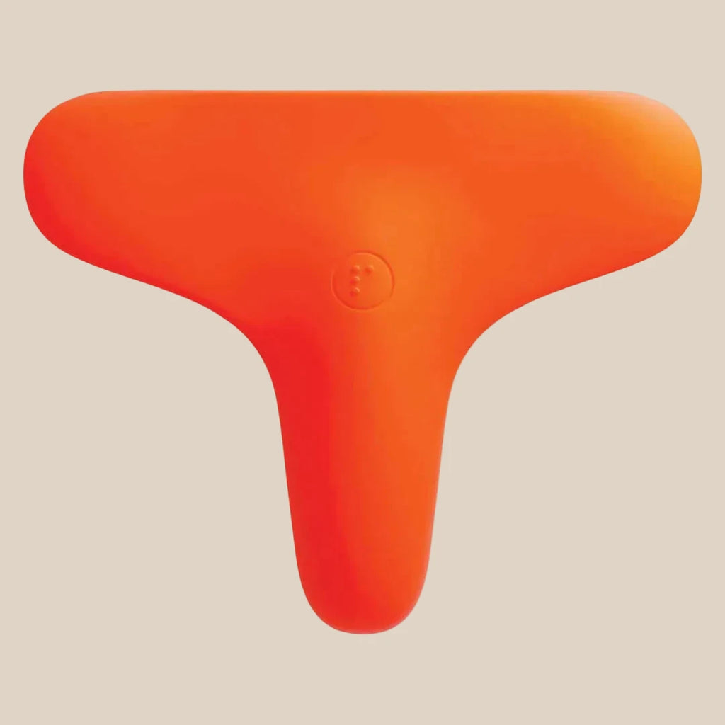 Bright orange, T-shaped multi-use silicone vibrator against a neutral background.