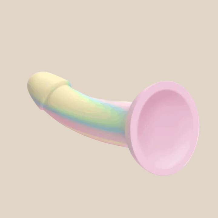 Rainbow silicone strap-on dildo with suction cup base on white background